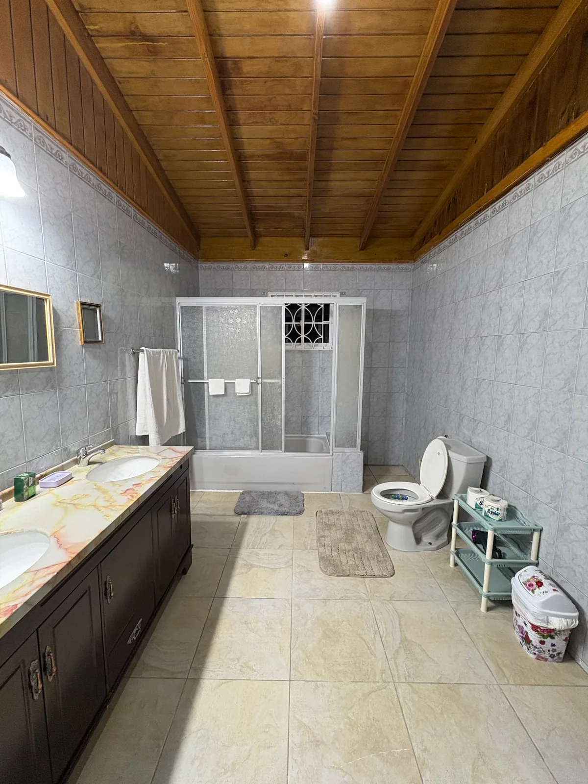 Tiled bathroom with a long vanity in Ocean View Villa
