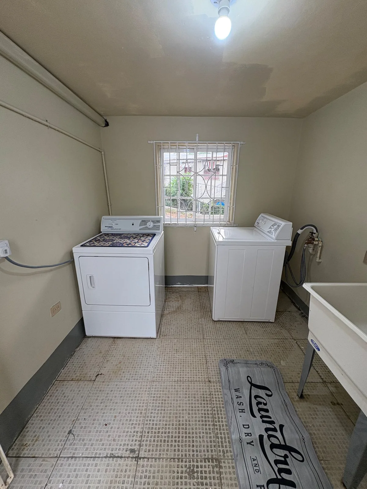 Washing machine and laundry sink shown in the Ocean View listing